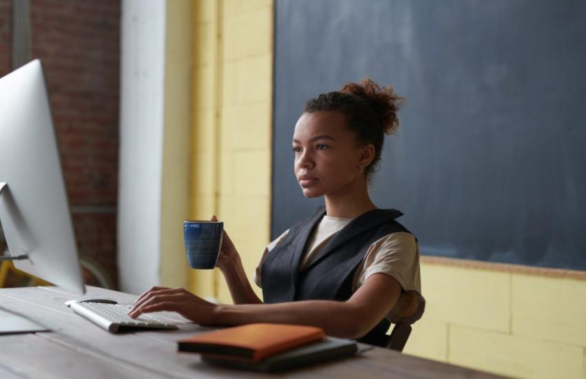 photo of woman holding mug