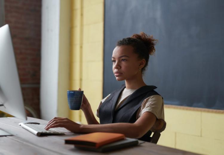 photo of woman holding mug